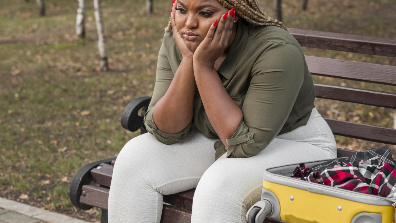 sad-woman-sitting-her-opened-luggage
